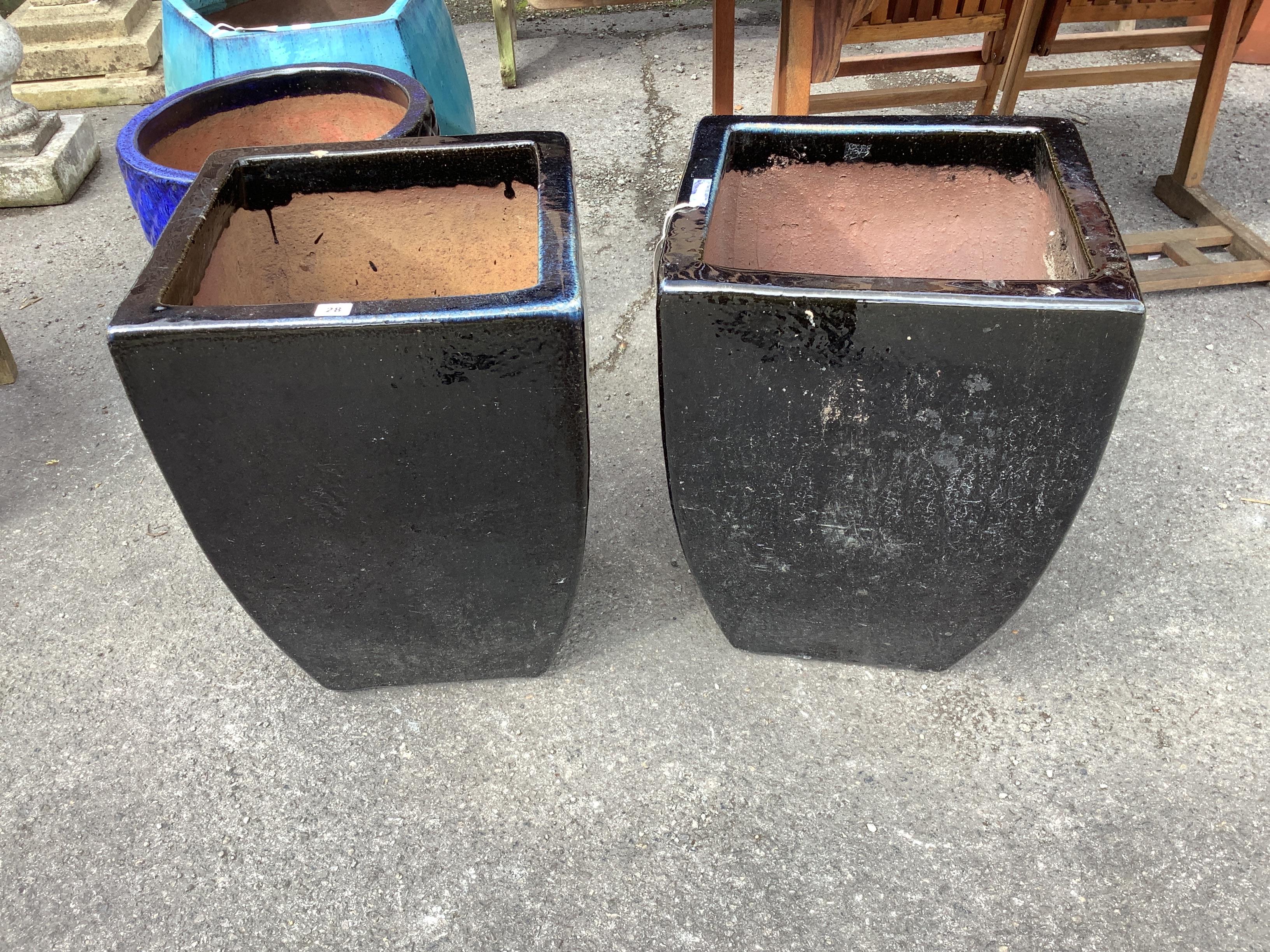 A pair of large black glazed square earthenware garden planters, 43cm, height 59cm